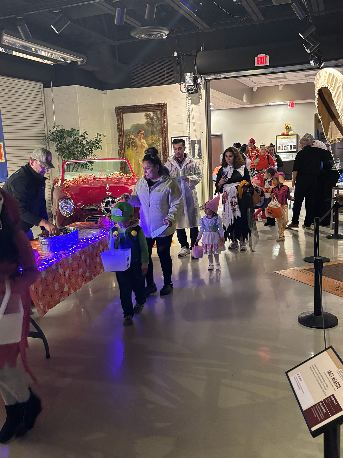 Children stand in line to receive candy at Trunk or Treat