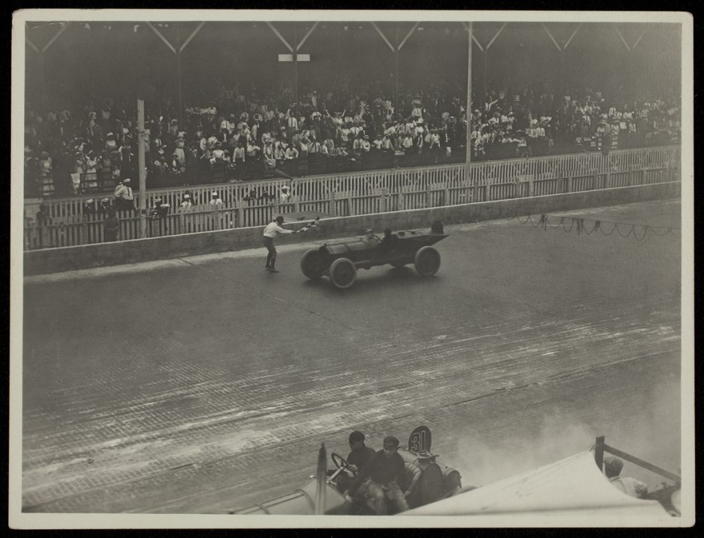 The Marmon Wasp Driven by Ray Harroun, Winner of the 1911 Indianapolis 500 crosses the finish line.